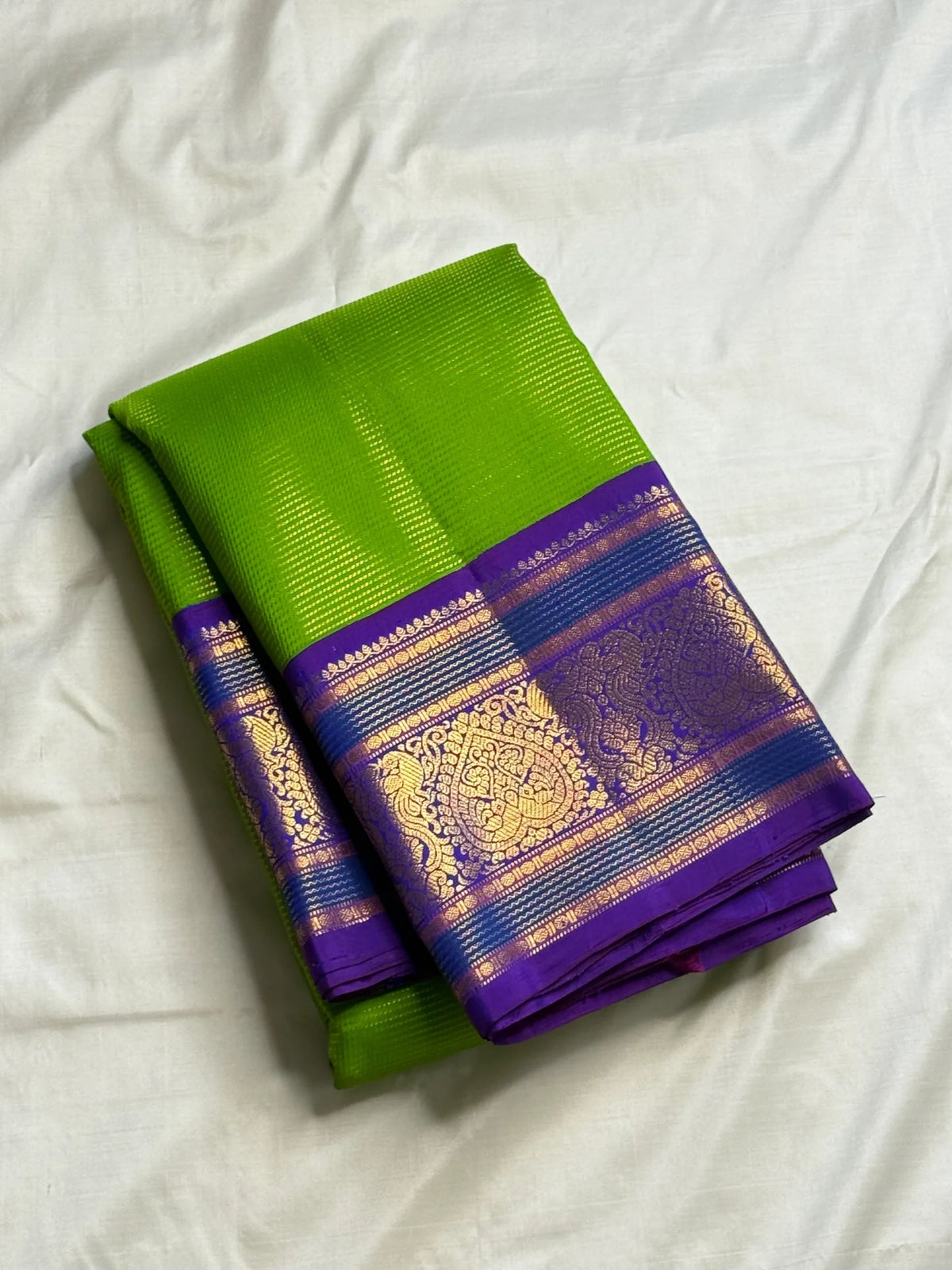 Close-up of the fine Vairaoosi weave texture on the Thulir Pachai green Kanchipuram silk saree