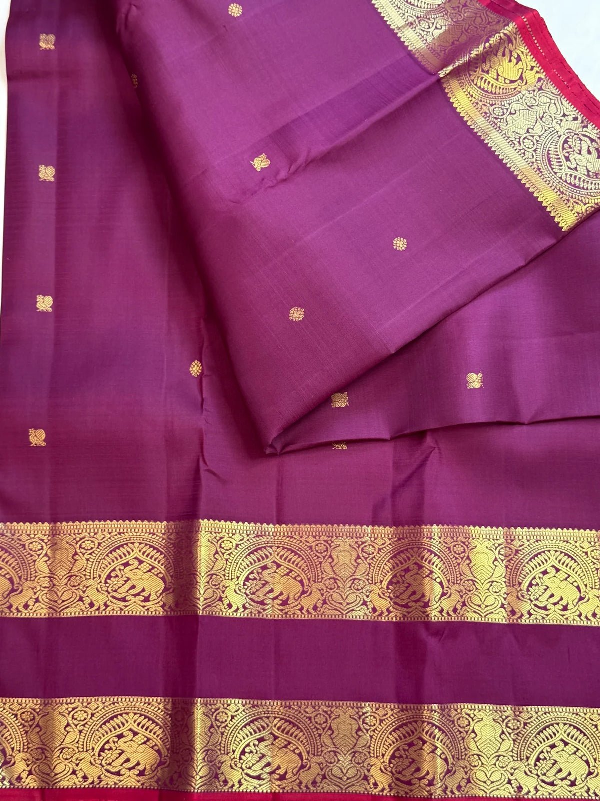 Jamun-plum Kanchipuram silk saree with Mayil Chakram motifs and peacock-green magenta Rettapet border