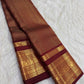 Warm arakku red Kanchipuram zari kattam saree, showing body, border and detailed gold zari pallu