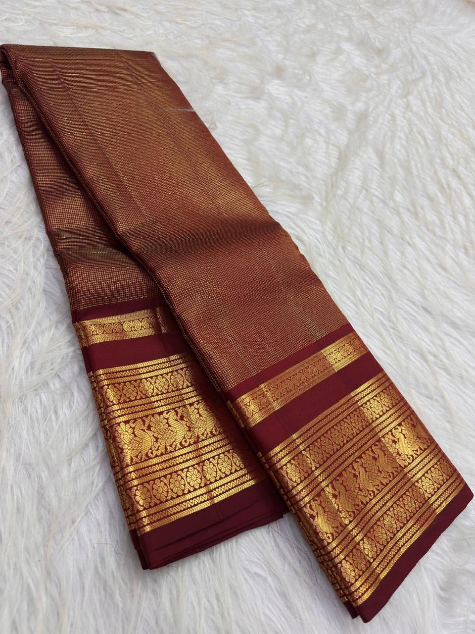 Warm arakku red Kanchipuram zari kattam saree, showing body, border and detailed gold zari pallu