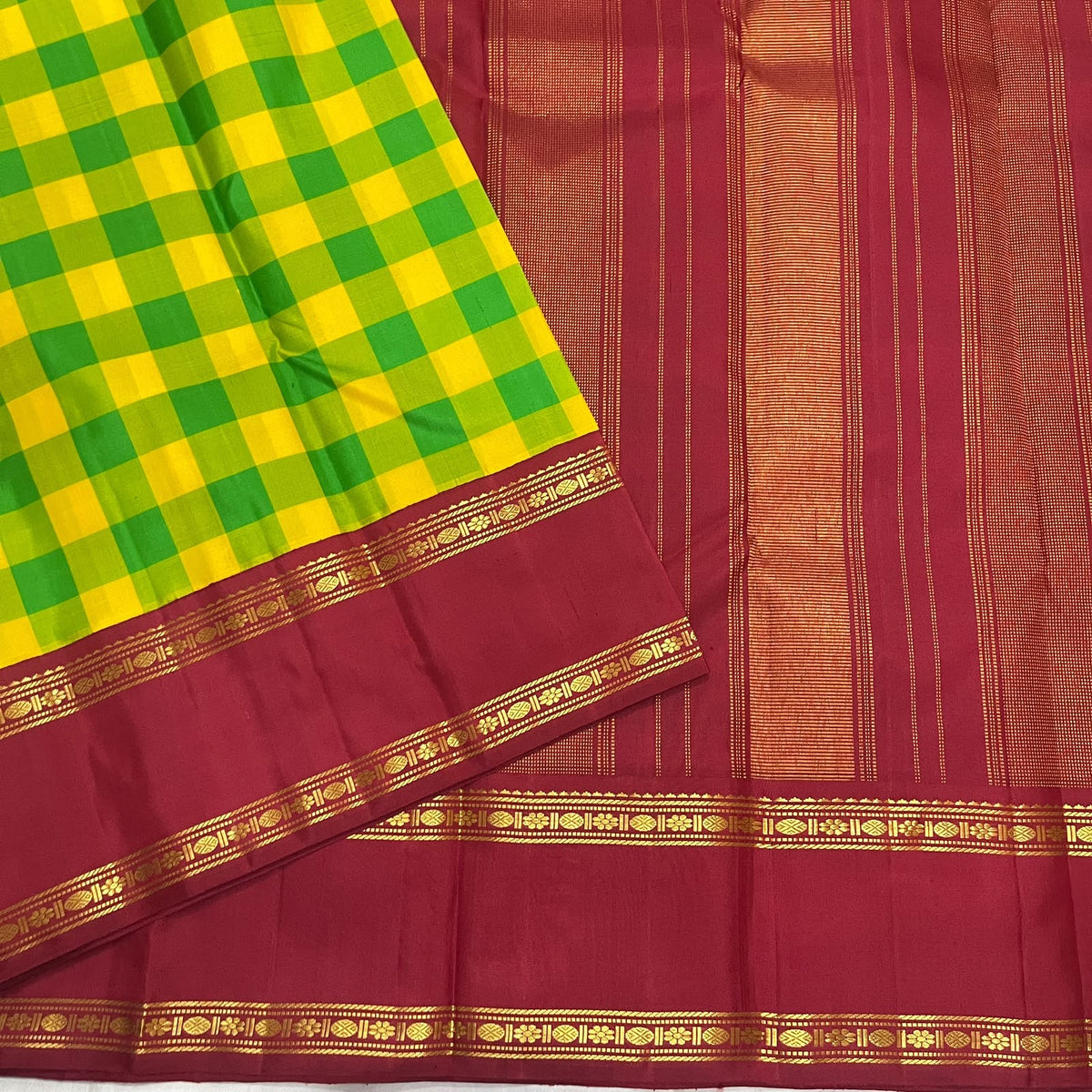 Grand pallu of the manjal yellow and ilai pachai Kanchipuram kattam saree finished with the red border