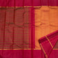 Broad vermilion-raspberry Rettapet border framed by antique-gold geometric bands on vintage Kanchipuram silk saree