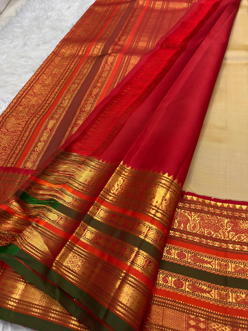 Sandalwood ivory Kanchipuram silk saree body with gold buttas.