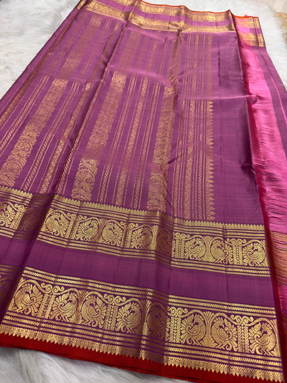 Twin peacock antique-gold Rettapet border bands with vermilion-red selvedge on rose pink purple Kanchipuram silk saree
