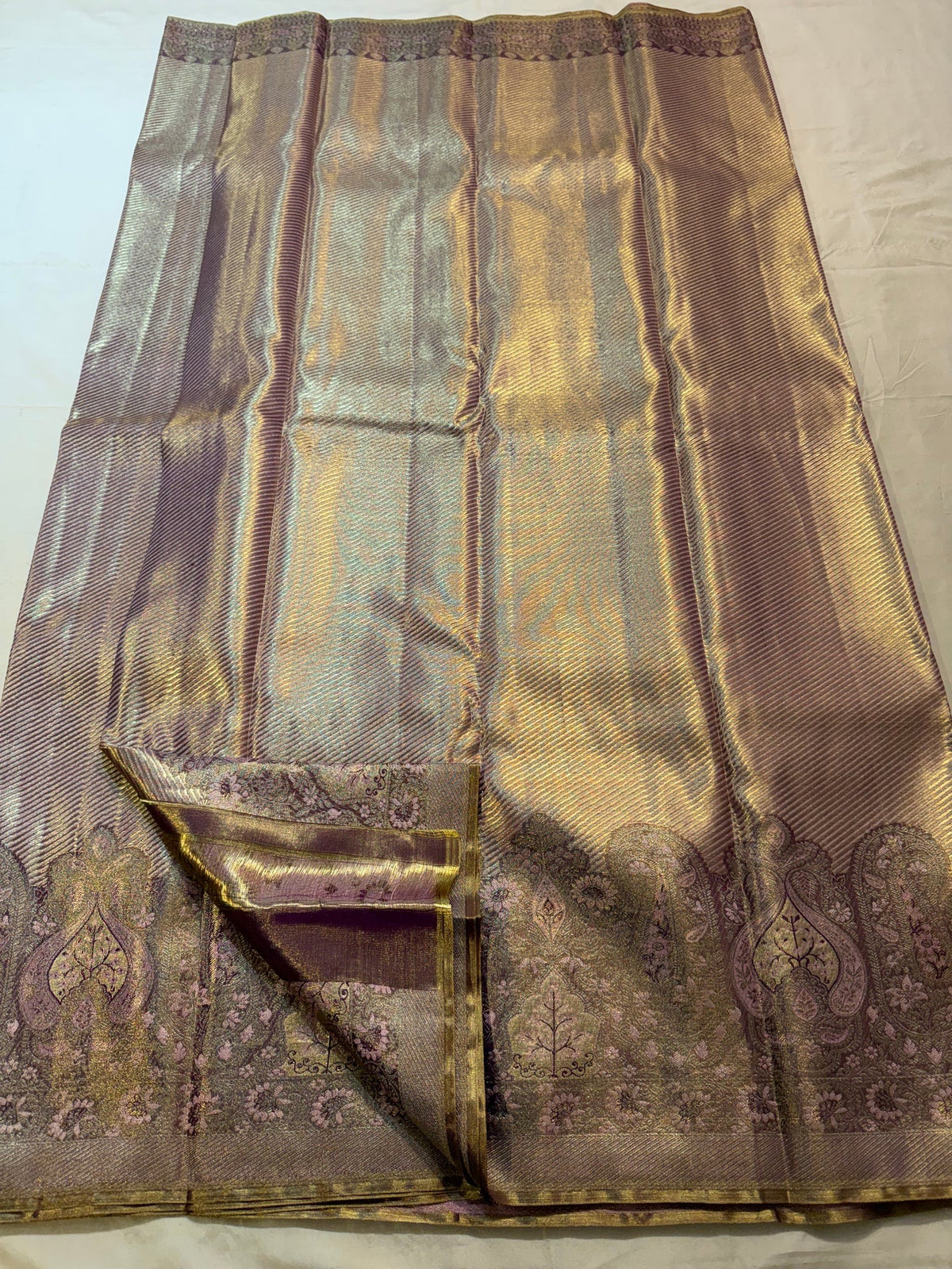 Broad Banarasi-inspired Kanjivaram border with paisley-like arches, floral work and deep maroon woven detailing.