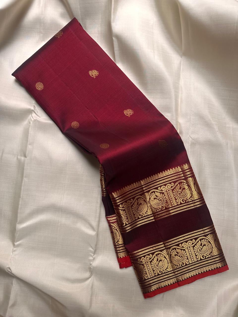 Deep arakku maroon handwoven pure silk Kanchipuram Rettapet saree with petite elephant buttas and twin peacock zari border, full view