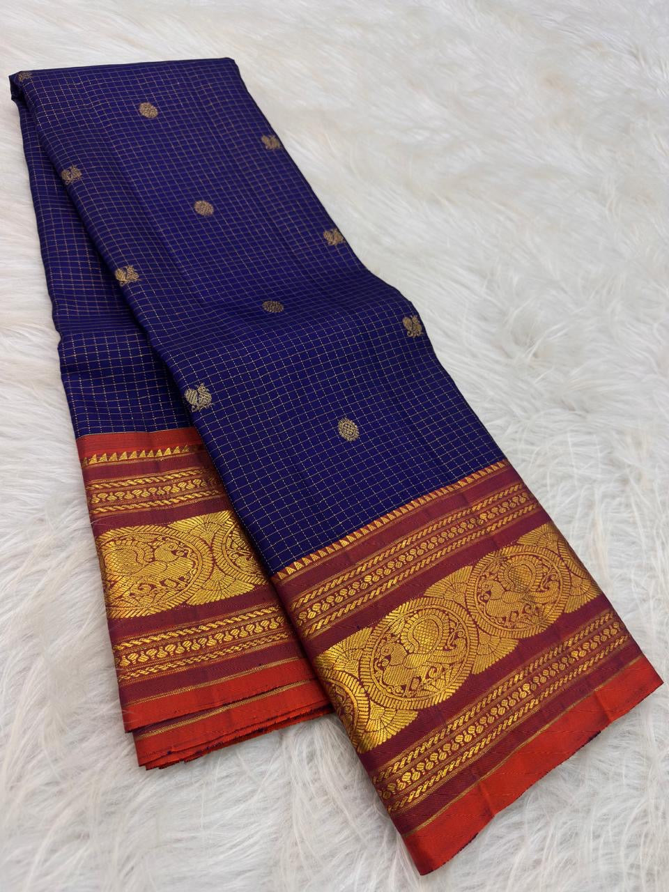 Deep Oodha blue Pure Kanchipuram Silk Zari Kattam saree with kesari-orange border worn at a temple satsang gathering
