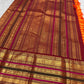 Marigold orange Kanchipuram saree with red and antique gold pallu.