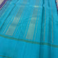 Handwoven turquoise Kanchi Kattam Kanchipuram silk saree with violet and ivory checks, styled for a Thanksgiving family dinner.