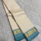 Ivory and turquoise blue Kanchipuram silk saree showing plain body, slim zari border and fine striped pallu