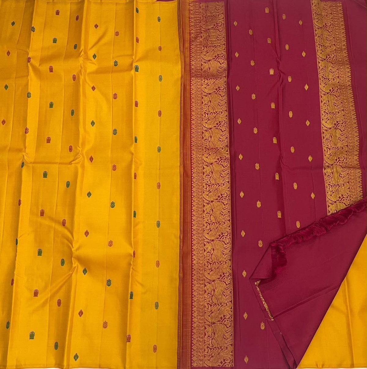 Close view of the handwoven floral silk-thread buttas on pure silk Kanchipuram saree