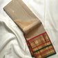 Sandalwood ivory Kanchipuram saree with gold buttas and Arakku red green ornate zari border.