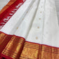 Warm ivory handwoven pure silk Kanchipuram Kai Korvai saree with gold zari flying horse buttas and temple-red border