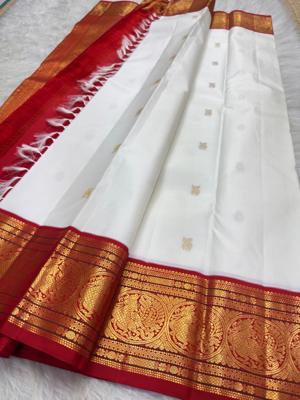 Warm ivory handwoven pure silk Kanchipuram Kai Korvai saree with gold zari flying horse buttas and temple-red border