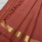 Soft terracotta rose Kanchipuram silk saree displaying tonal body, fine zari pallu lines and slim gold border
