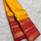 Manjal yellow and arakku red Kanchipuram Varisaipet silk saree with layered zari border and Vanki Pettu bands