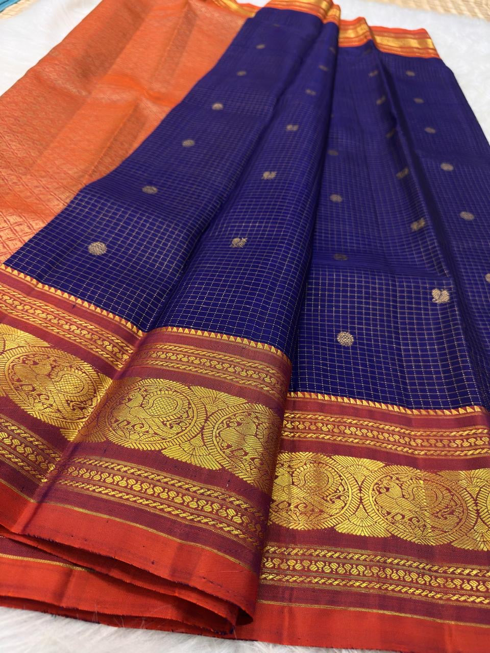 Close-up of the Deep Oodha blue Kanchipuram Zari Kattam silk saree pallu during a temple kumkumarchana