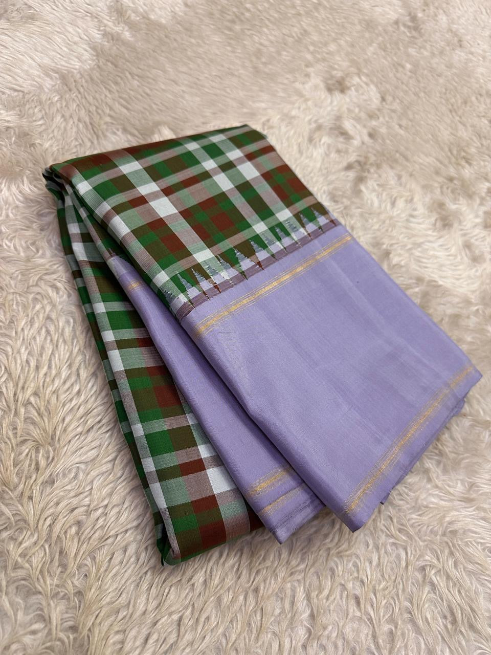 Mullai Lavender Multicolour Kanchi Kattam Kanjivaram pattu silk saree with gold zari pallu, styled for a wedding-day temple ceremony.