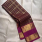 Oodha magenta Pure Kanchipuram Silk Zari Kattam saree with Rettapet border worn at a wedding-day temple ceremony