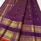 Peacock feather border detail woven in gold zari on deep purple Kanchipuram silk