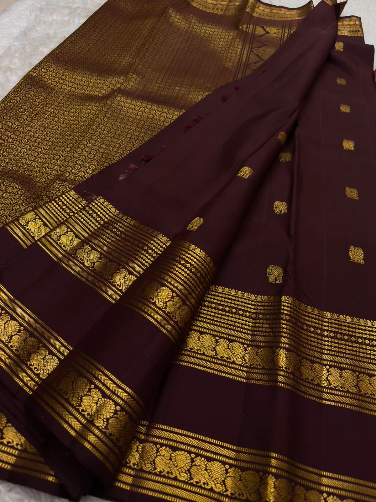 Deep Arakku brown Kanchipuram silk saree with small gold Mayil and Kamalam buttas