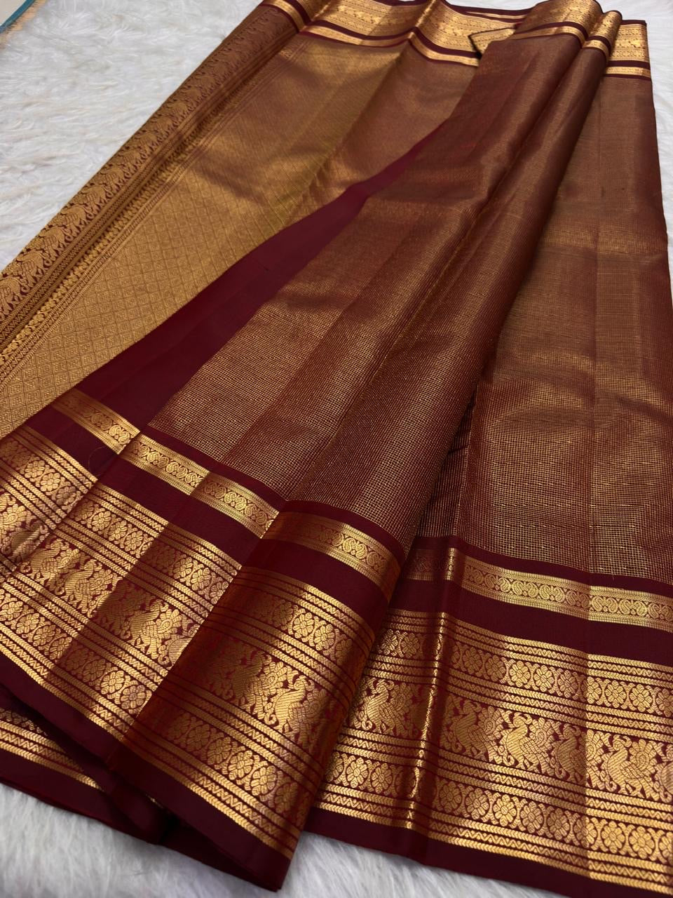 Warm arakku red Kanchipuram zari kattam saree, showing body, border and detailed gold zari pallu