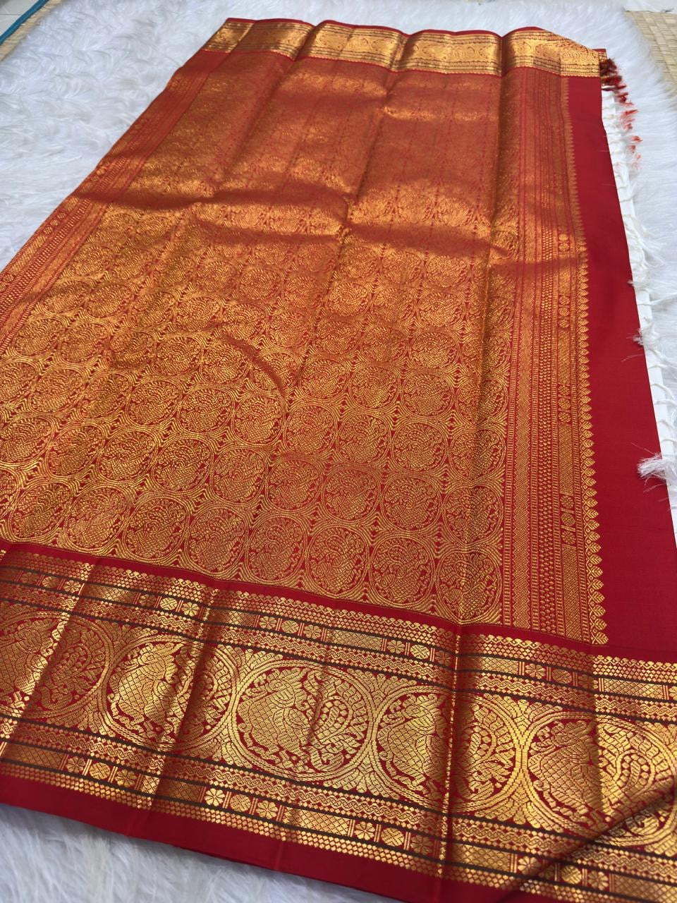 Warm ivory handwoven pure silk Kanchipuram Kai Korvai saree with gold zari flying horse buttas and temple-red border