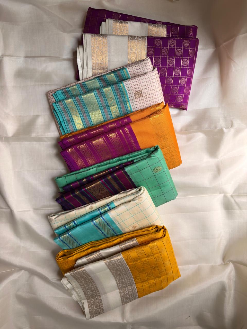 Kancheepuram silk saree aqua body with antique gold zari motifs and contrast plum border close view