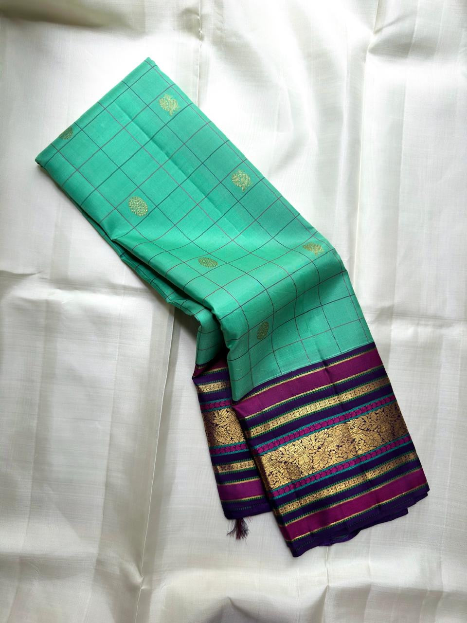 Kanchipuram silk saree sea aqua tone with grid design and plum zari border pallu detail