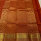 Close-up of the gold zari Butta motifs on the burnt-orange Kanjivaram silk saree