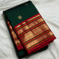 Detail view of gold zari weaving on chili red varisaipet border of pure Kanjivaram silk saree — Idam Living