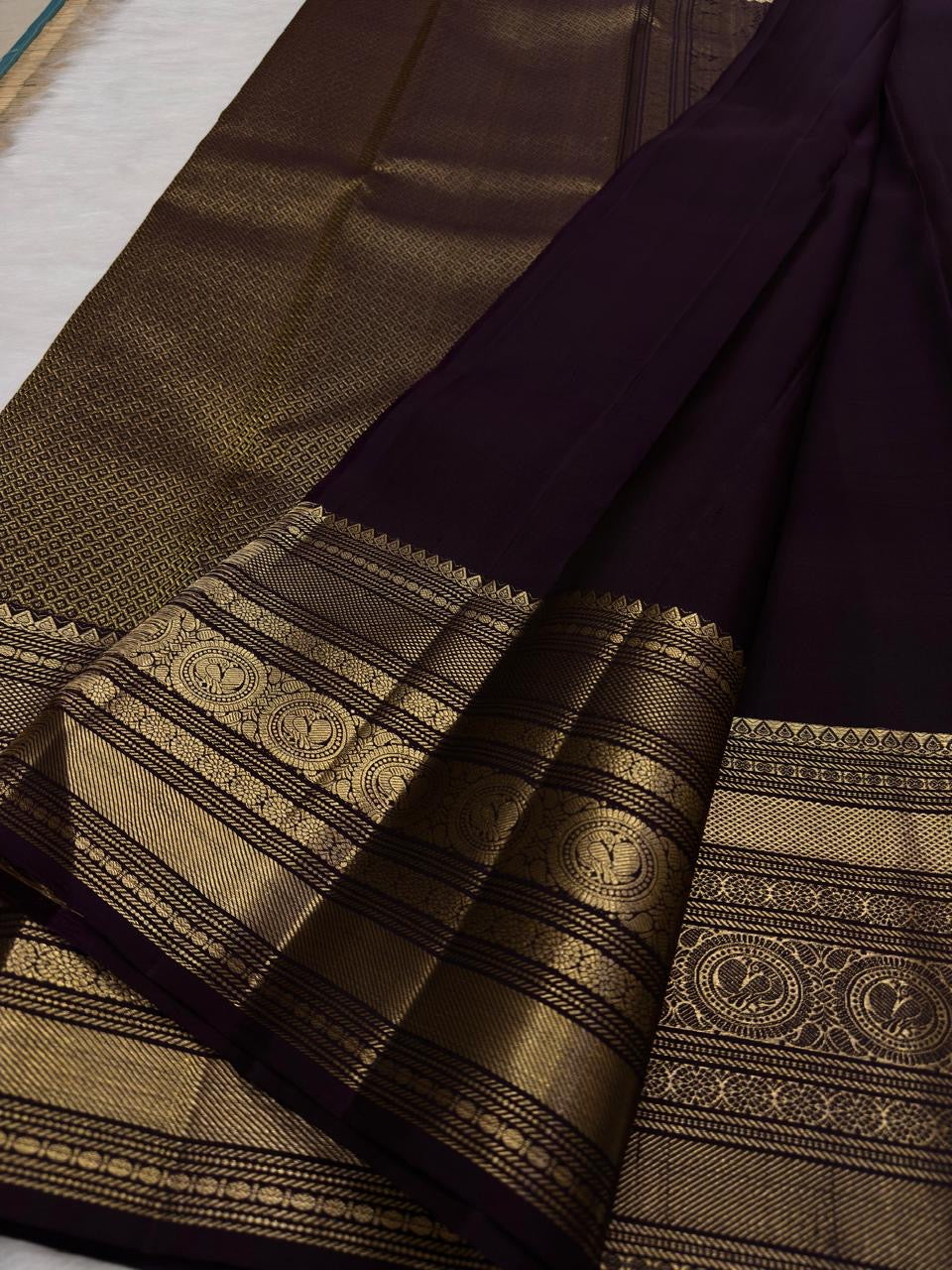 Coffee brown pure silk Kanchipuram saree with antique gold mayil chakram buttas, deep green accents, and a detailed peacock and arai maadam pallu, view 3.