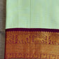 Pastel Kanchipuram silk saree full drape with subtle zari lines and soft glow finish