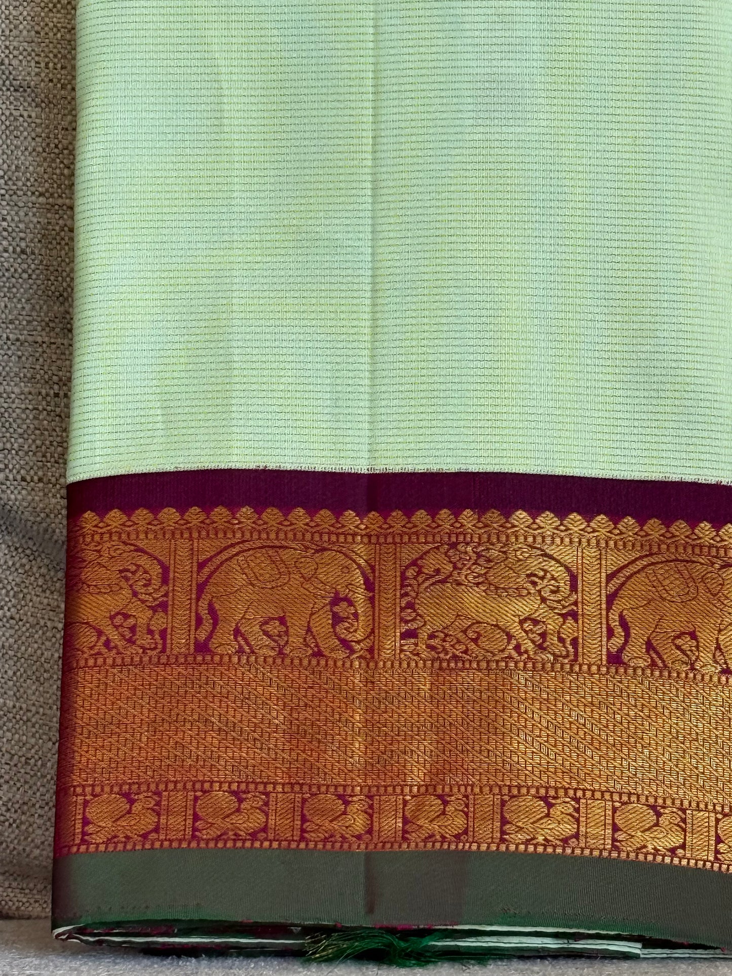 Pastel Kanchipuram silk saree full drape with subtle zari lines and soft glow finish