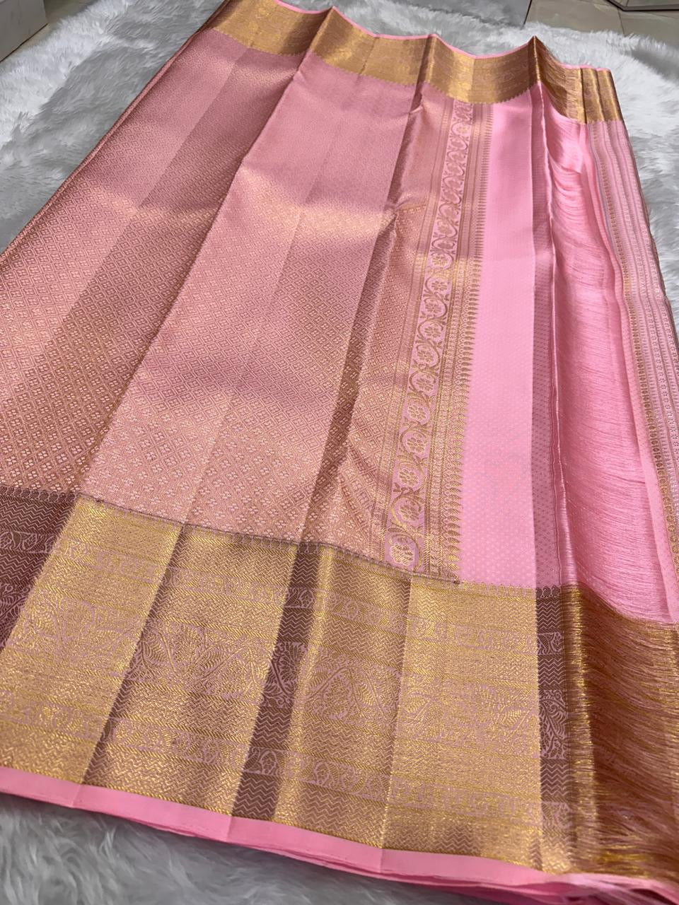 Kancheepuram silk saree pink body apricot border pallu detail traditional zari