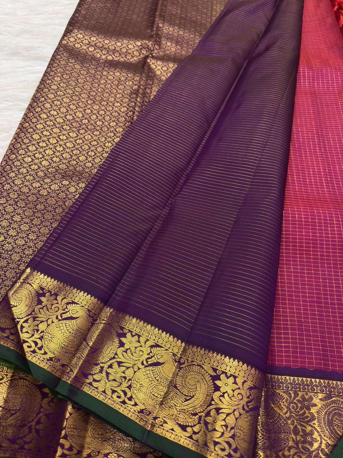 Close view of gold zari kattam checks and petite floral buttas on raspberry red pure silk Kanchipuram saree body