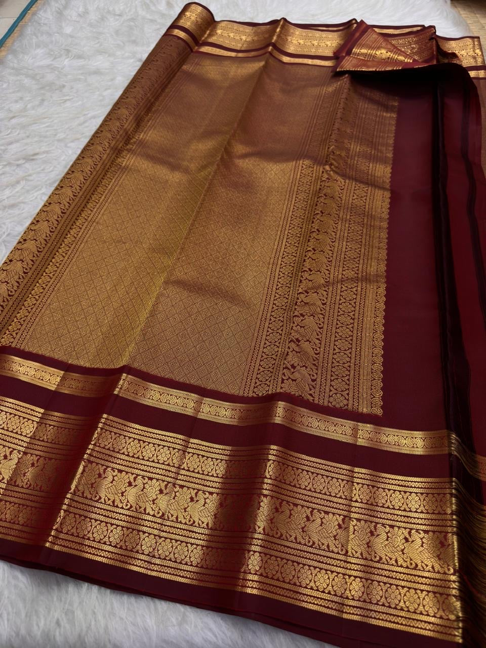 Warm arakku red Kanchipuram zari kattam saree, showing body, border and detailed gold zari pallu