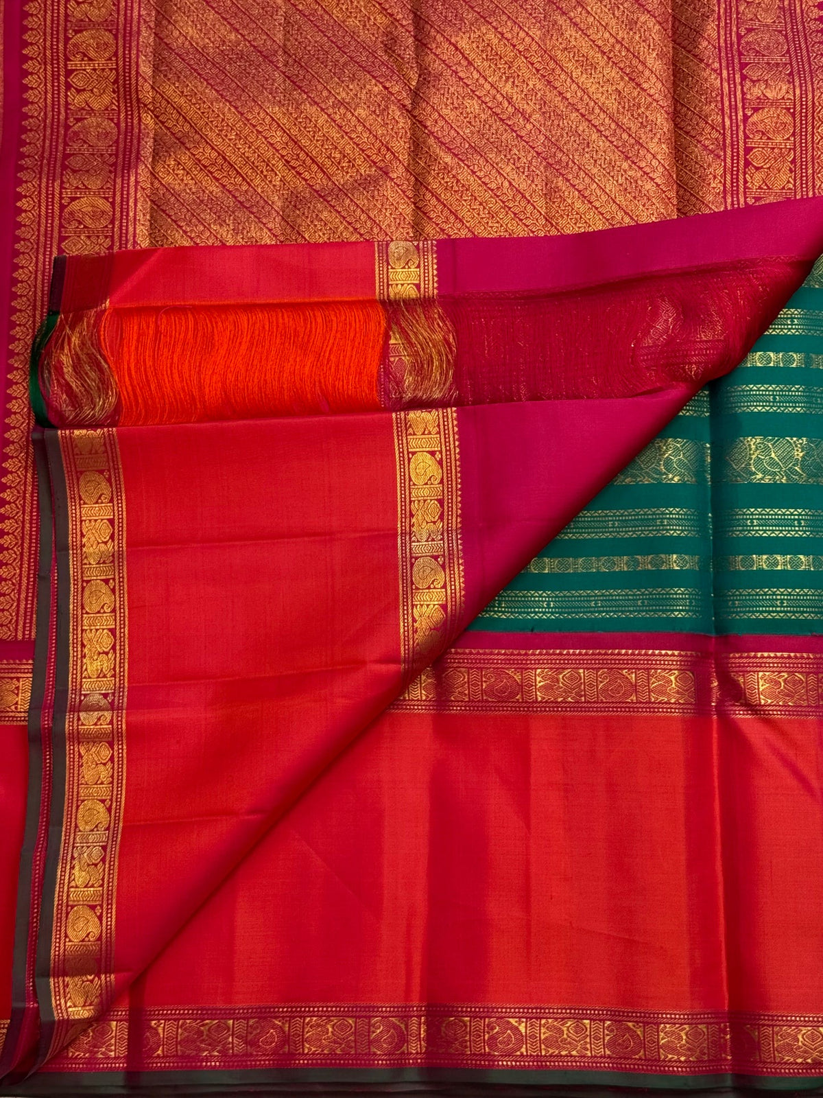 Grand rich pallu in antique gold and red on a peacock-green pure silk Kanchipuram saree