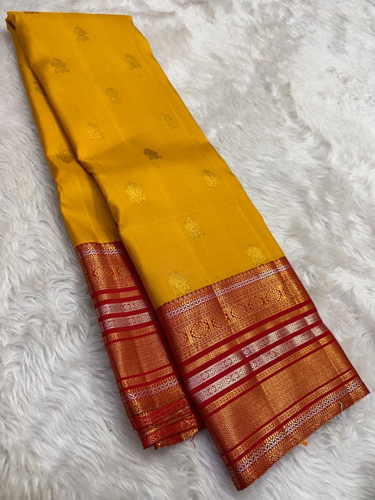 Yellow Kanjivaram saree with red varisaipet zari border detail close up