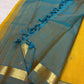 Turmeric yellow Kanchipuram silk saree opened to show peacock blue striped zari pallu and narrow border