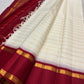 Ivory Veldhari Korvai Kanjivaram silk saree with contrasting Ganga Jamuna border, worn for a Sudarshana Homam.