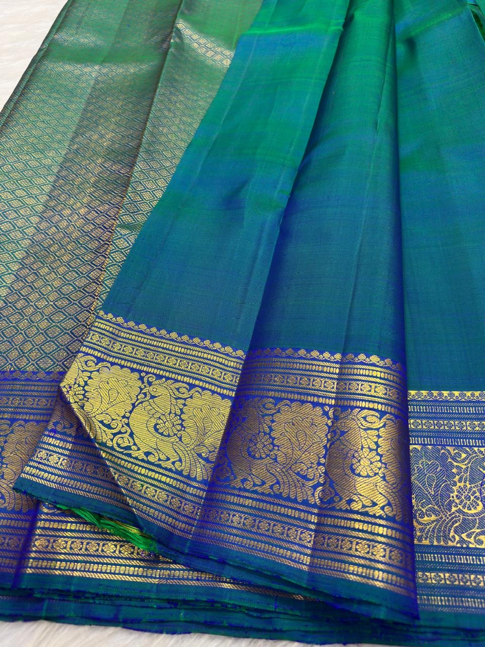 Peacock Blue, emerald green, royal blue and antique gold handwoven Kanchipuram butta silk saree, body silk detail, with gold zari detailing.