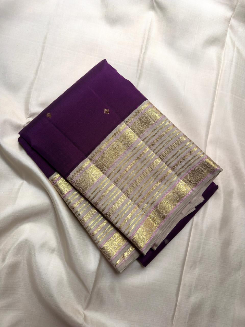 Deep Kathiripoo purple Kanchipuram silk saree with Varisaipet border detail.