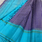Turquoise-blue Kanchi Kattam pure silk saree with oodha-violet and ivory checks and green selvedge lines, styled for a South Asian women's awards night.
