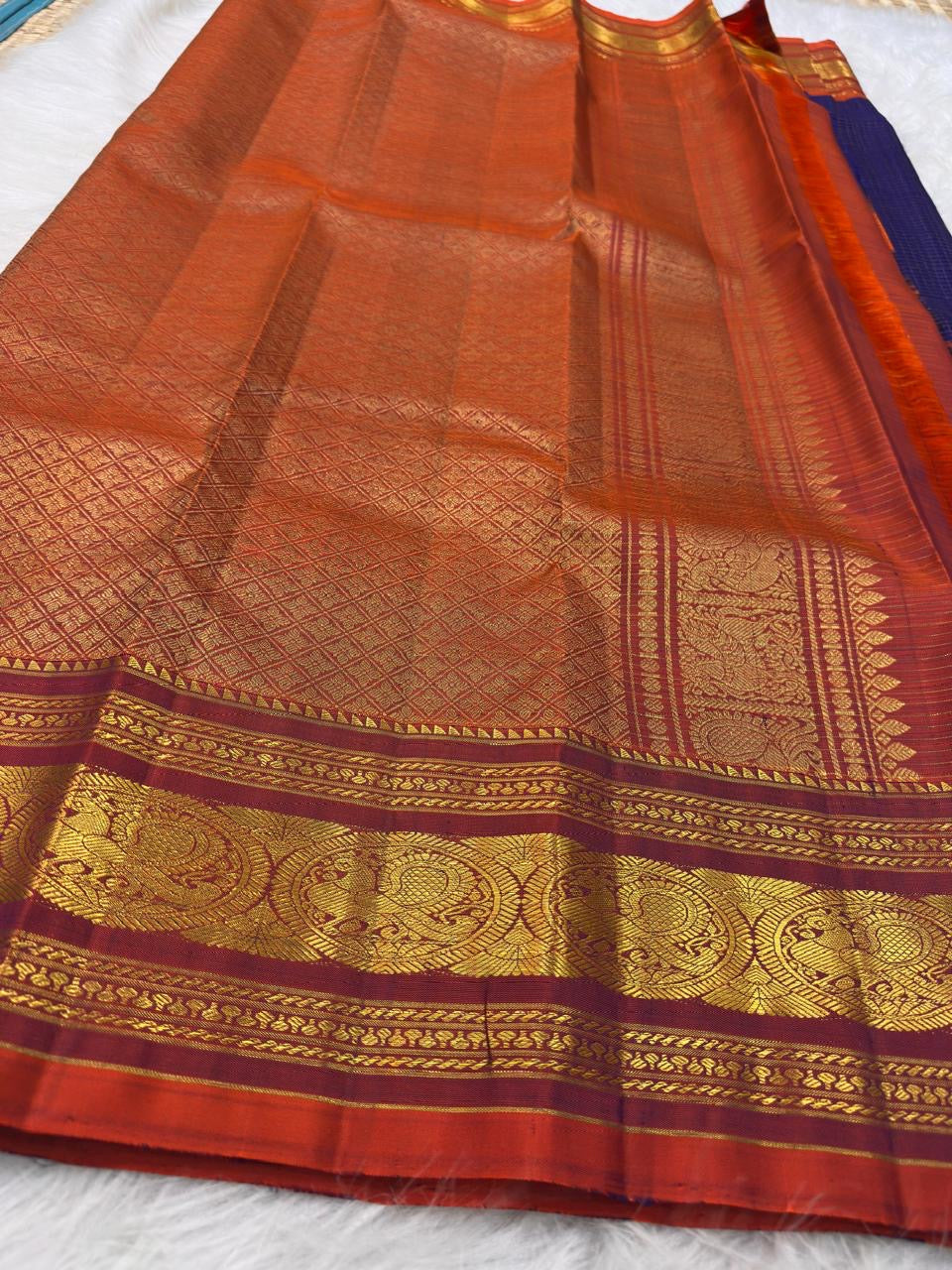 Deep Oodha blue Kanchipuram Zari Kattam silk saree with copper-gold pallu at a Sri Chakra puja gathering