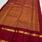 Ivory Kanjivaram silk saree with grand patterned gold zari pallu and Ganga Jamuna border, worn for a Laksharchana Puja.
