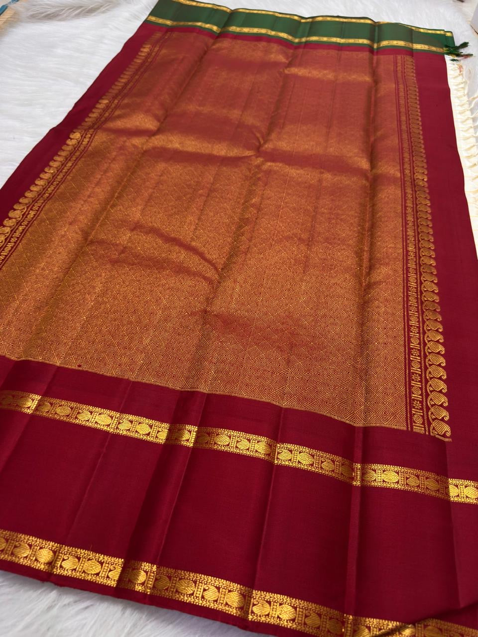 Ivory Kanjivaram silk saree with grand patterned gold zari pallu and Ganga Jamuna border, worn for a Laksharchana Puja.