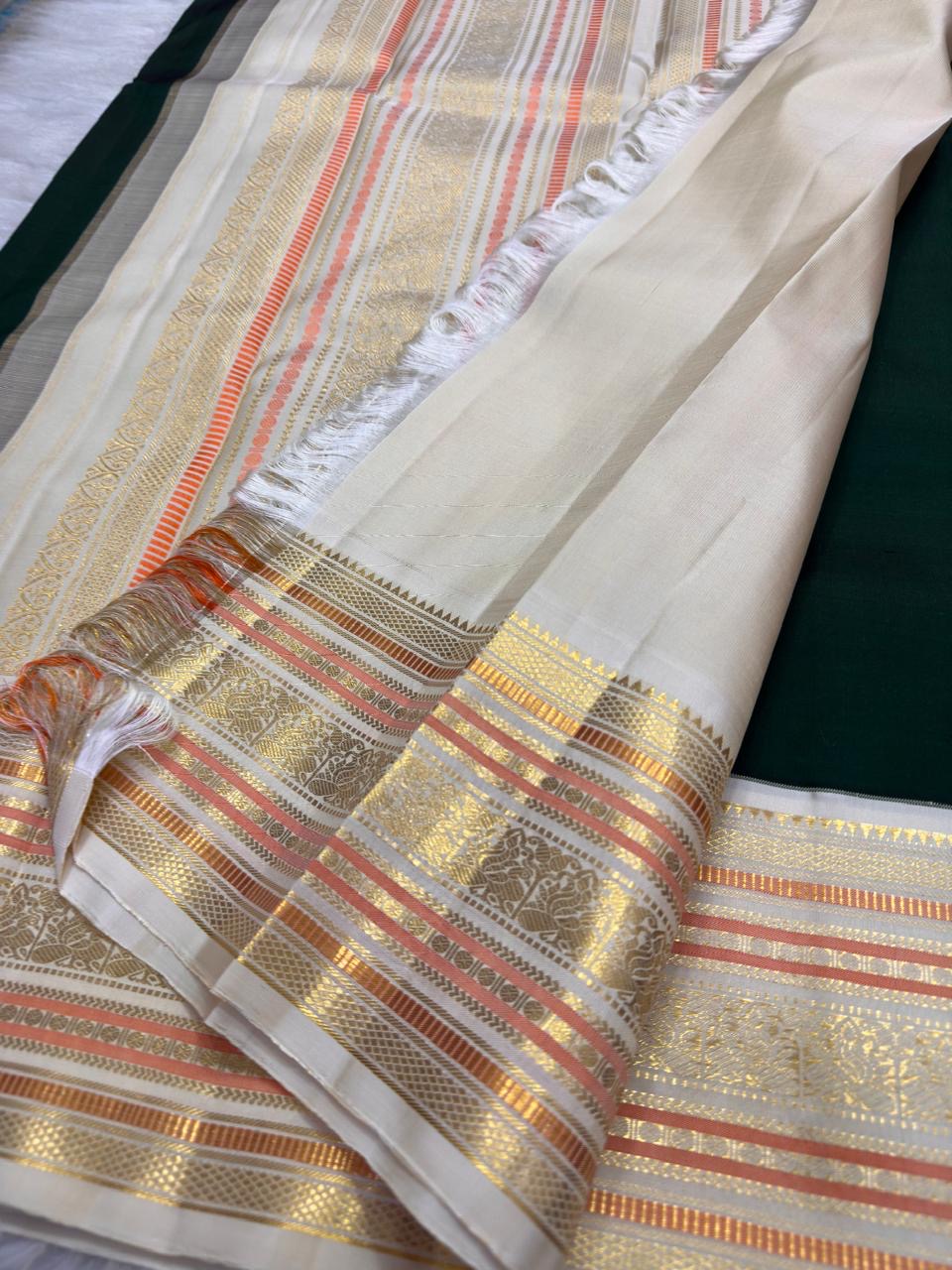 Ornate pallu and border of Warm Ivory & Deep Forest Green Varisaipet Kanchipuram silk saree with traditional zari and silk-thread work.