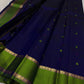 Karu Neelam silk body with green silk-thread buttas scattered across the open field and pink pinpoint accents.
