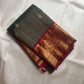 Close detail of dual-tone gold and silver zari buttas on the Adar Pachai Kanchipuram silk.